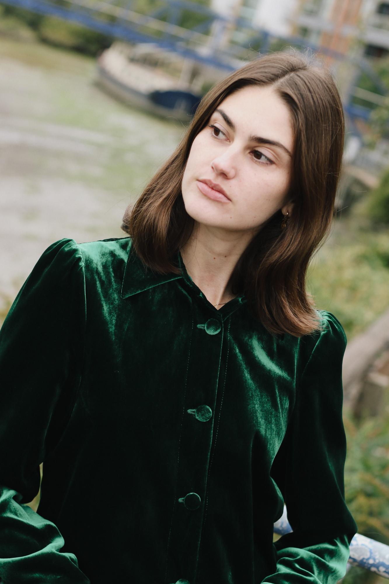 Woman wearing the velvet Gentlewomen Jacket in green outside 