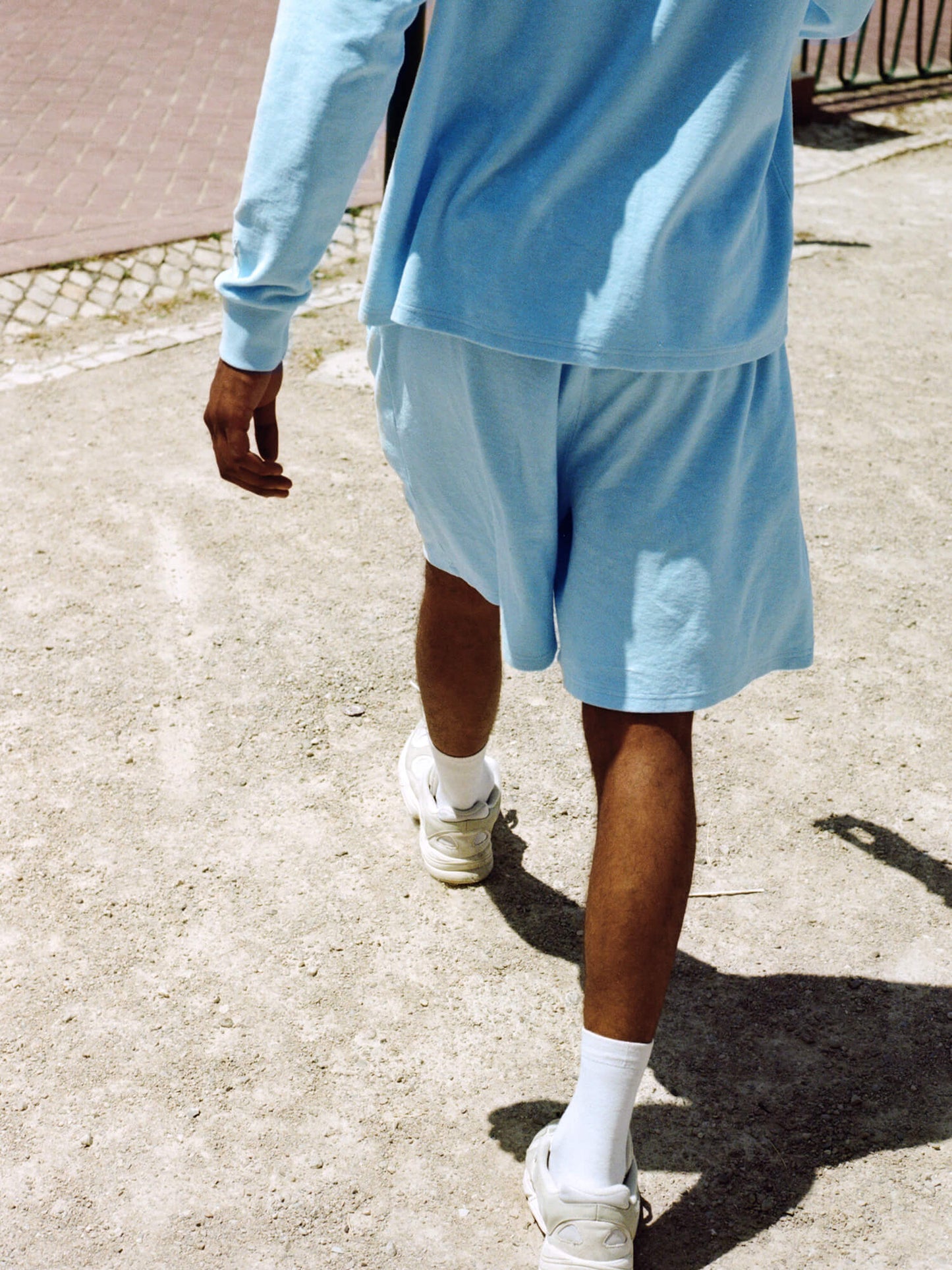 man wearing Organic Terry Long-sleeve in sky blue walking