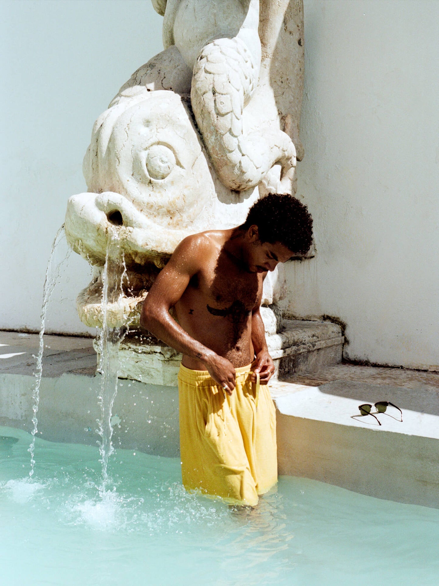 man in pool wearing Organic Terry Shorts in golden sand
