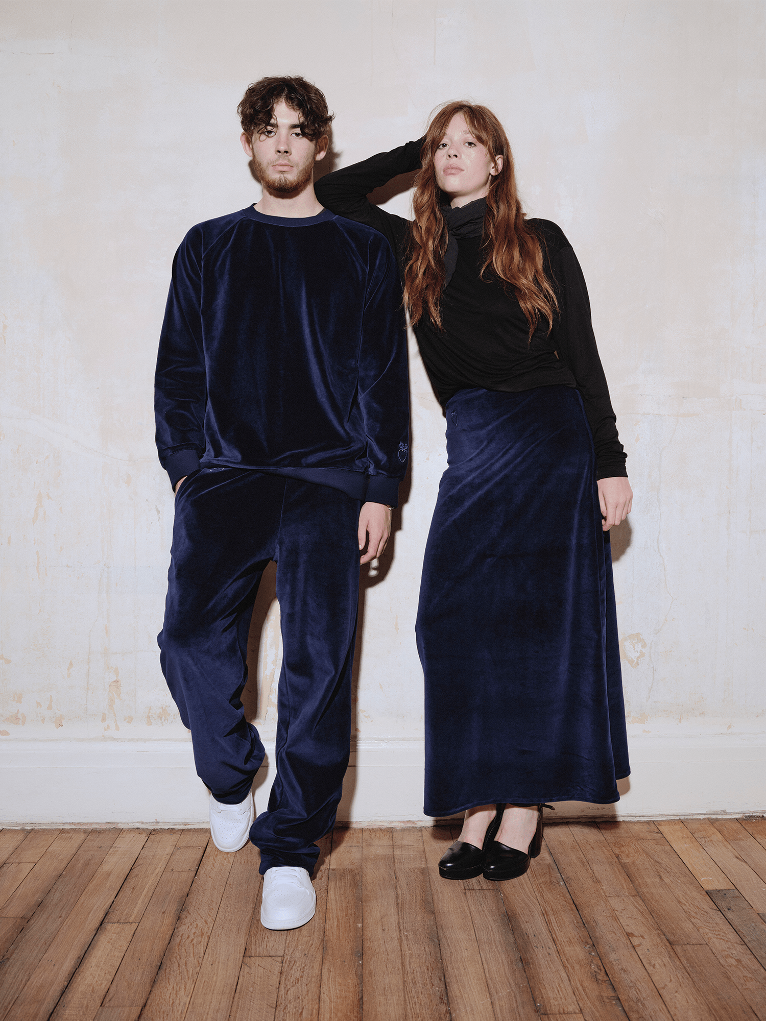 model wearing Heavy Velour A-line Skirt in midnight blue leaning against man