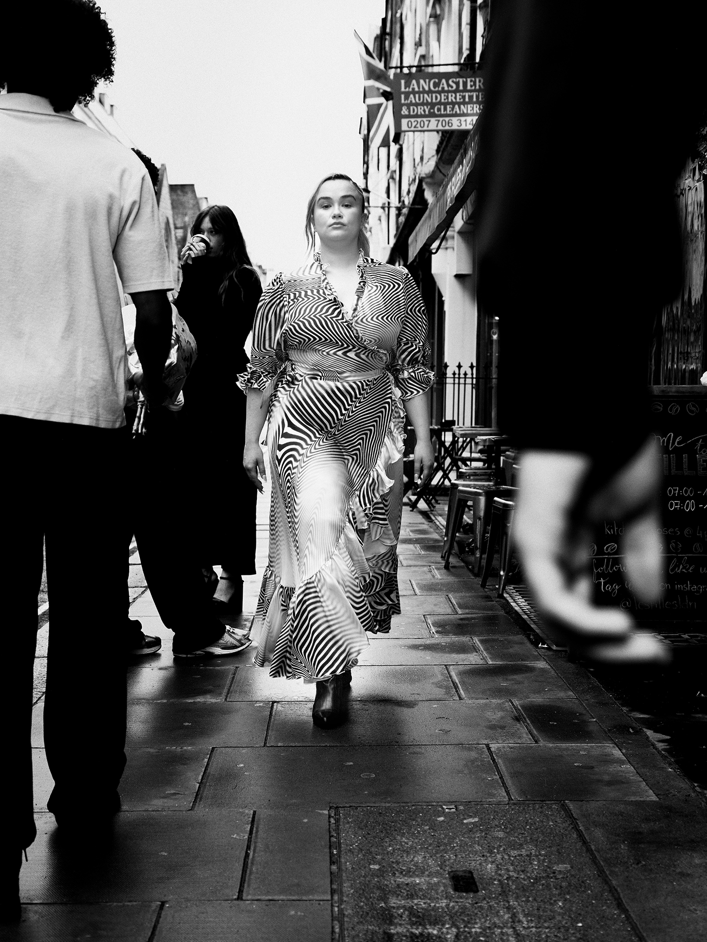 woman wearing The Wrap Dress 2.0 in zebra pattern walking down busy street