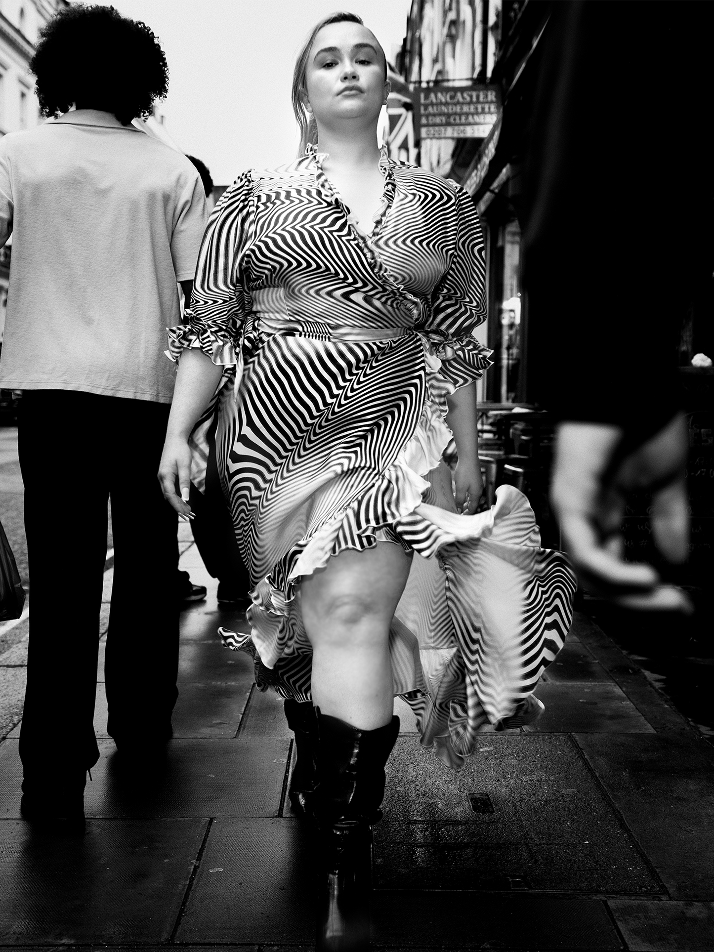 woman wearing The Wrap Dress 2.0 in zebra pattern walking down busy street, close up