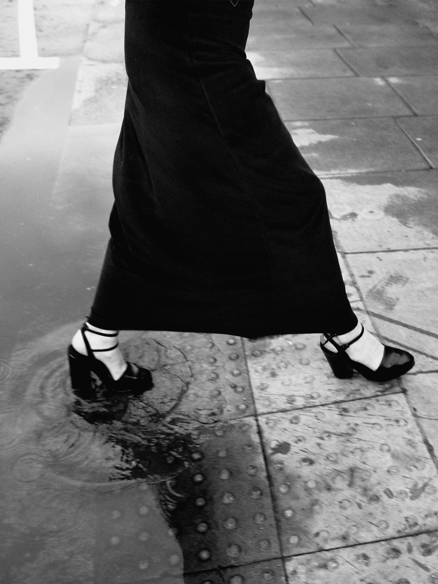 woman stepping out of puddle in heels wearing Heavy Velour A-line Skirt in midnight blue