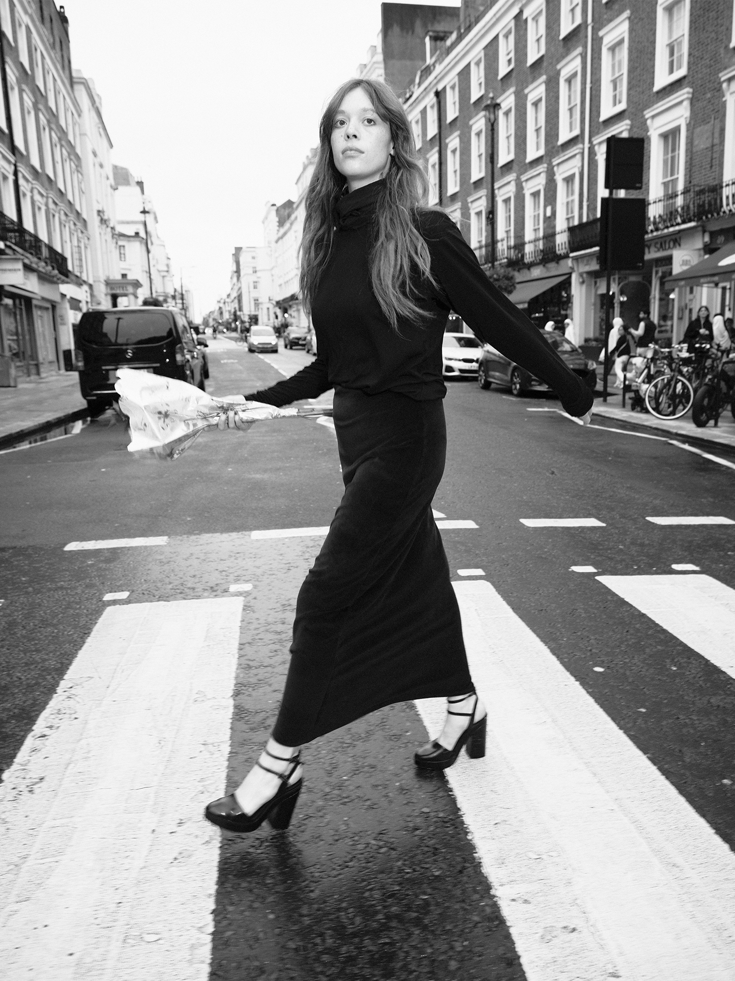 woman walking across zebra crossing holding flowers wearing Heavy Velour A-line Skirt in midnight blue