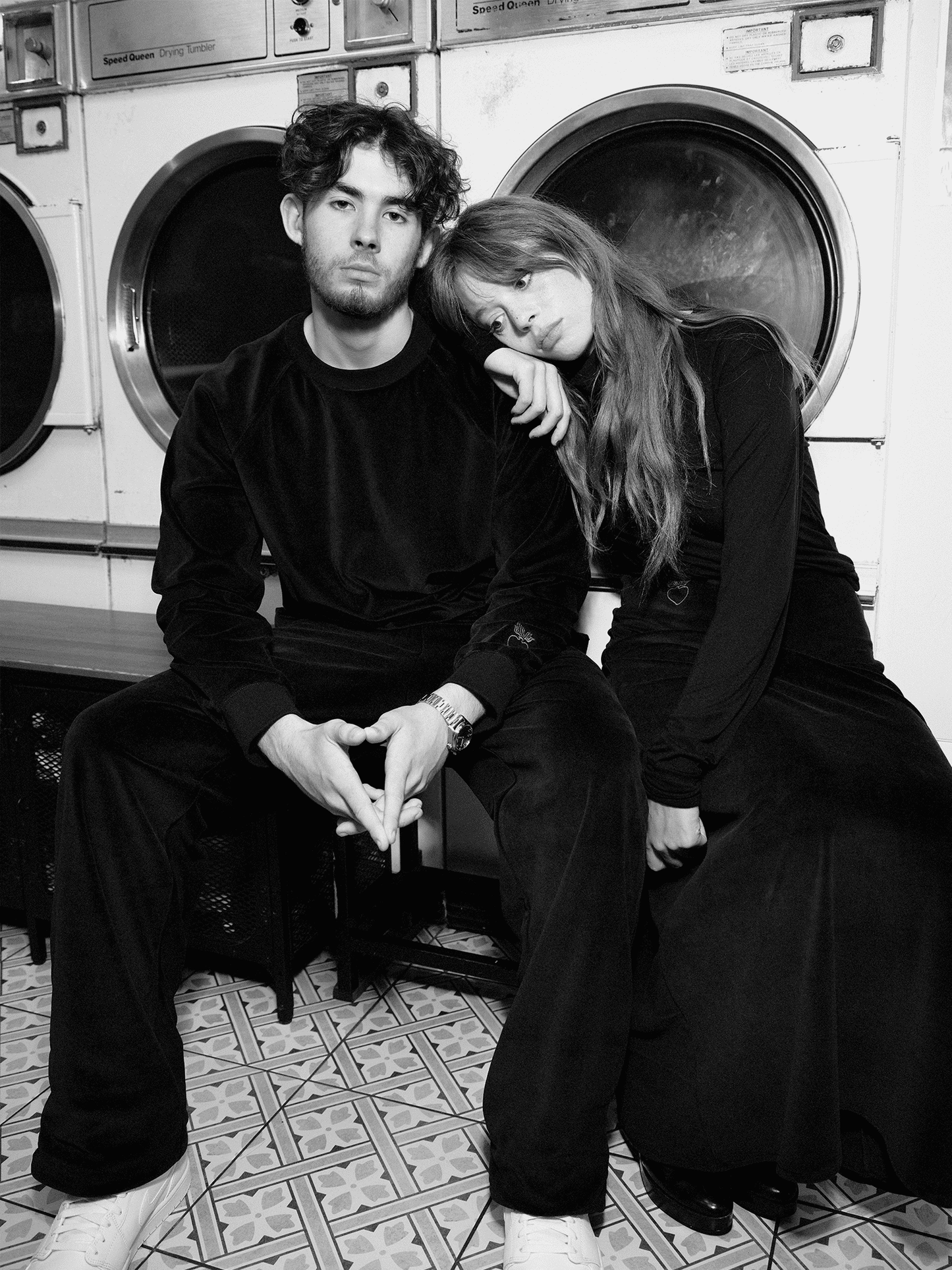 model wearing Heavy Velour A-line Skirt in midnight blue in laundrette leaning against man
