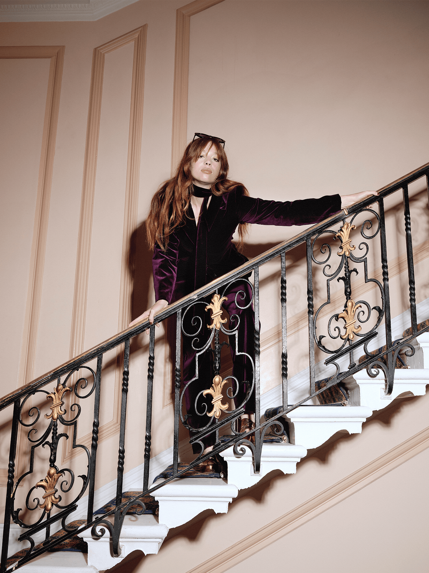 woman on staircase modelling the Cotton Velvet All-Day Suit Trousers in purple