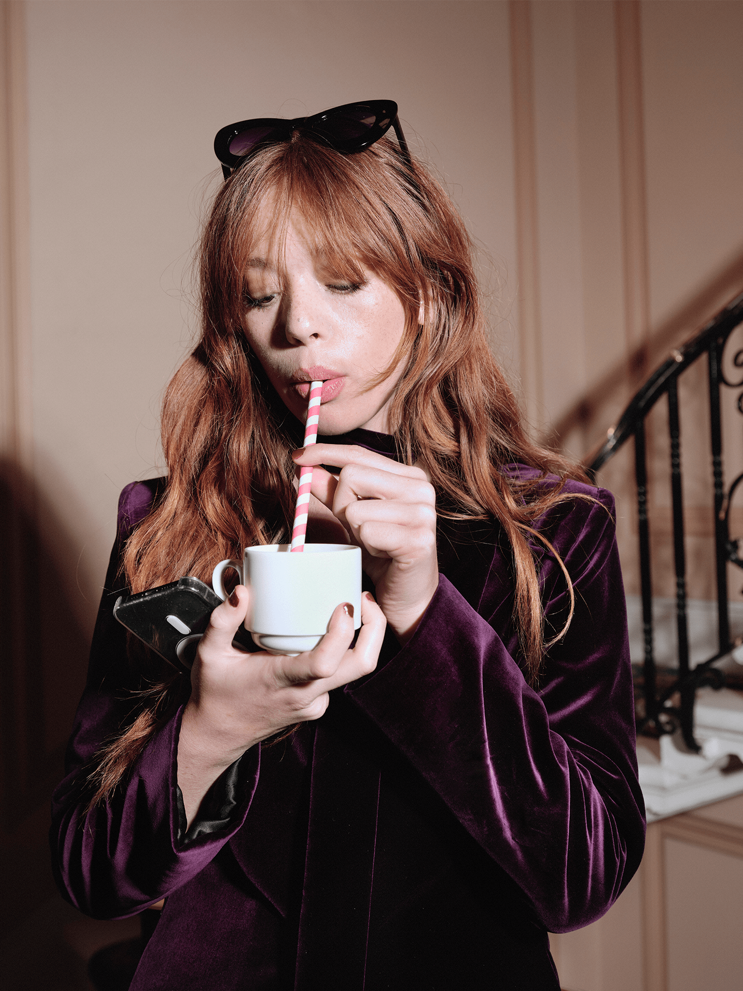 women modelling Cotton Velvet All-Day Suit Trousers in purple whilst sipping drink from teacup with stripey straw