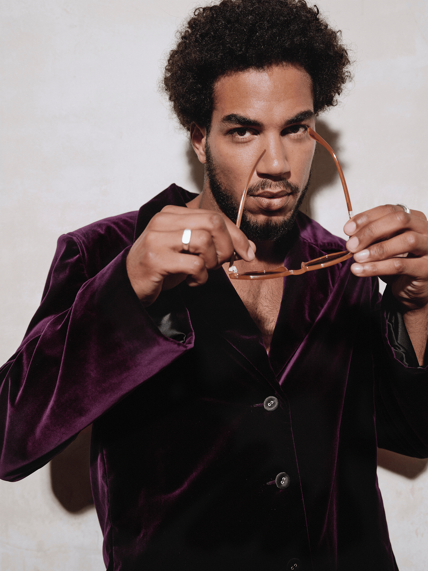 man modelling Cotton Velvet All-Day Suit Trousers in purple putting on sunglasses