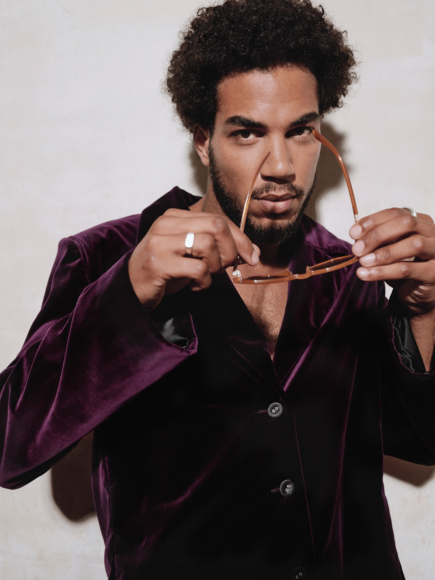 man modelling Cotton Velvet All-Day Suit Trousers in purple putting on sunglasses