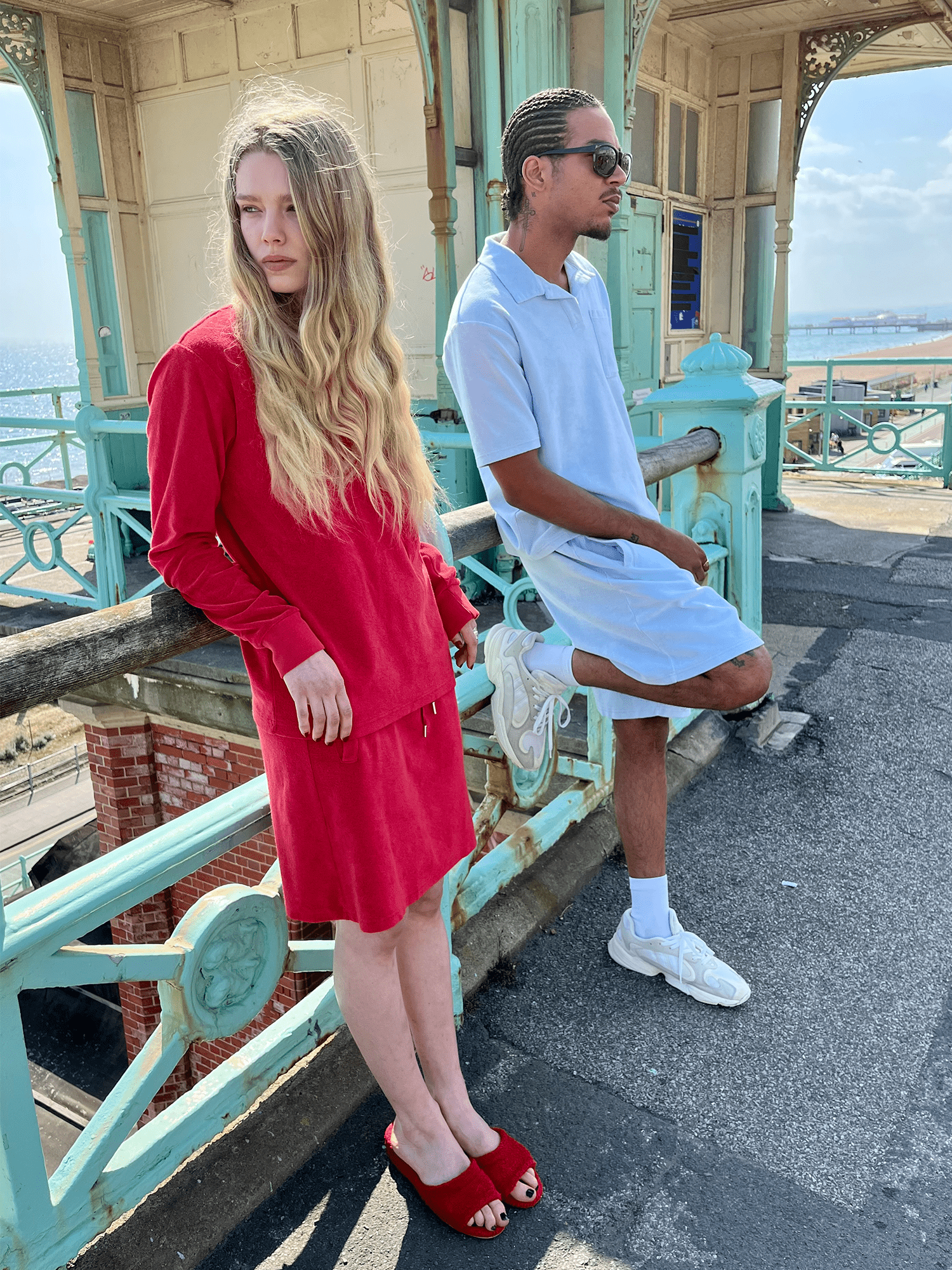 man wearing Organic Terry Polo in sky blue wiht woman in red outfit
