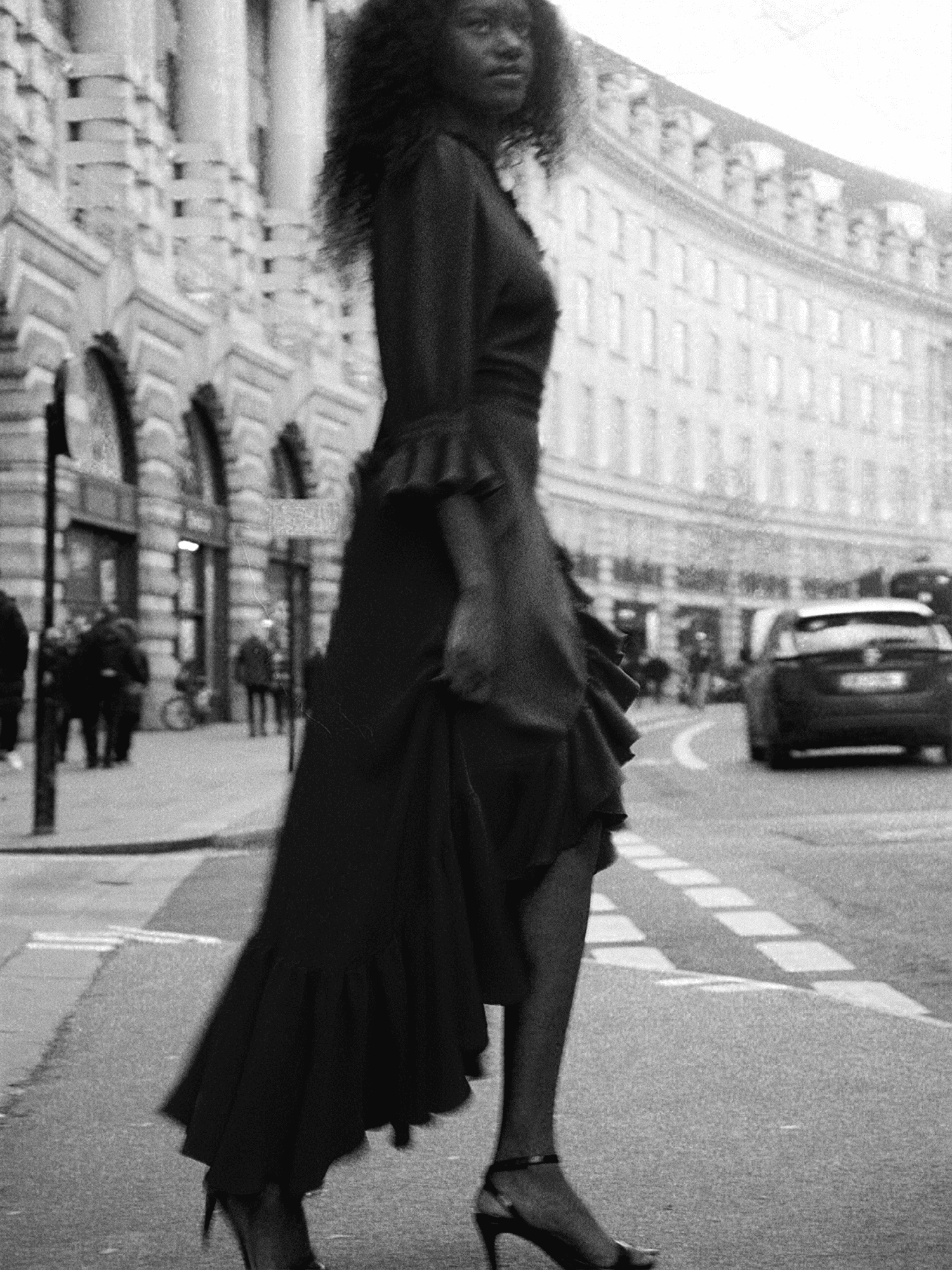 woman by street wearing The Wrap Dress in raven black,