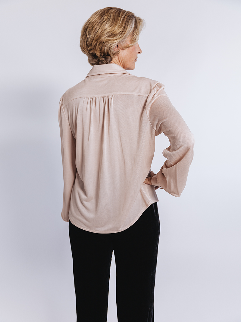 older woman modelling Slinky Pique Shirt in blush, back view
