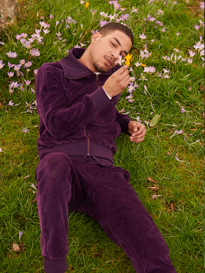 man modelling Organic Velour Tracksuit Bottoms in purple