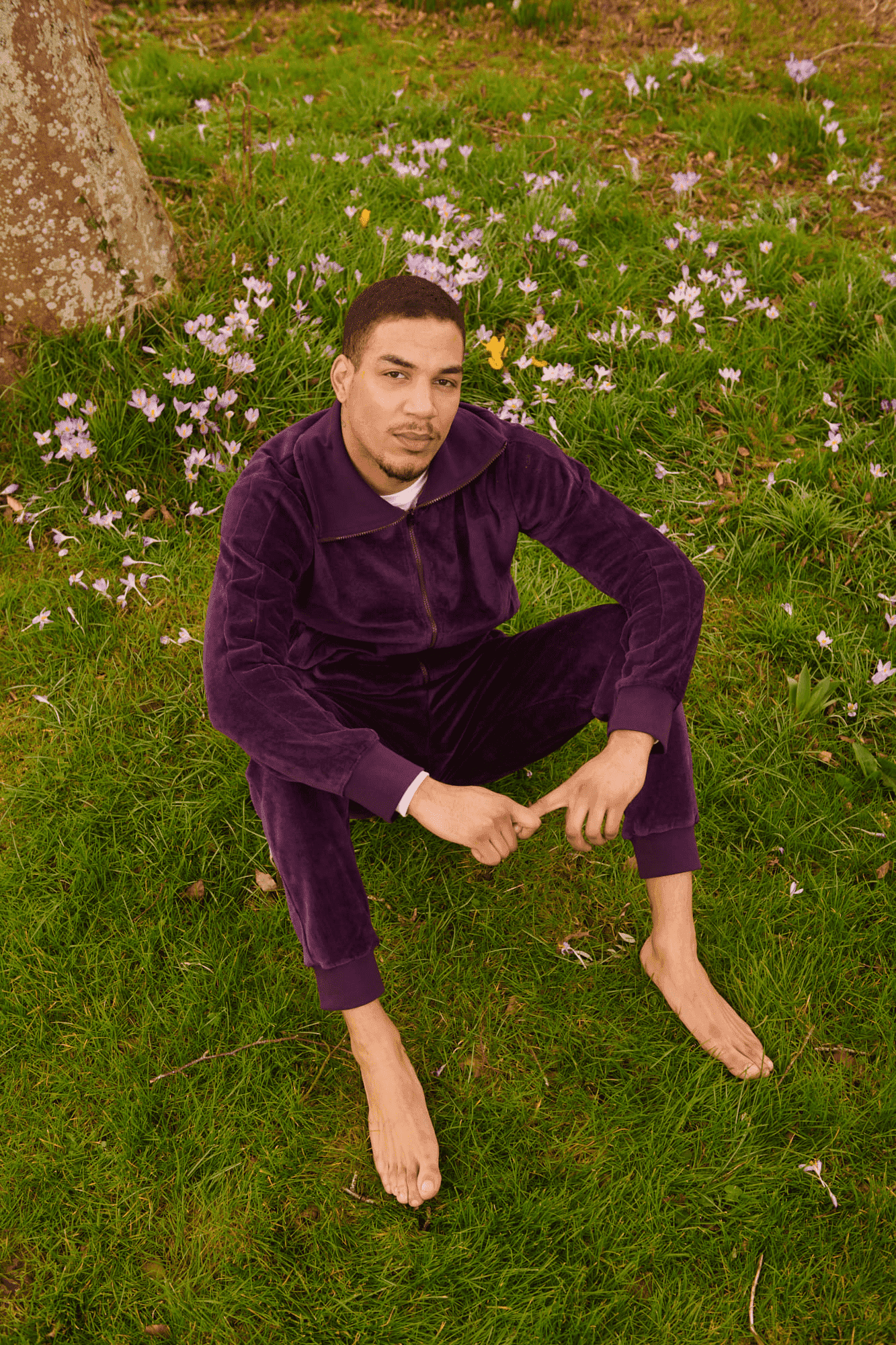 man in field modelling Organic Velour Tracksuit Bottoms in purple