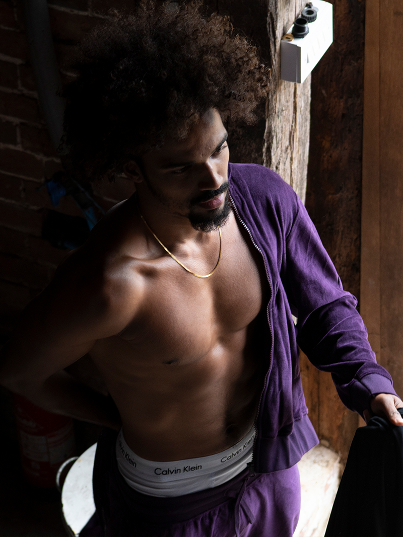 man wearing undone Organic Velour Zip Jumper in royal purple