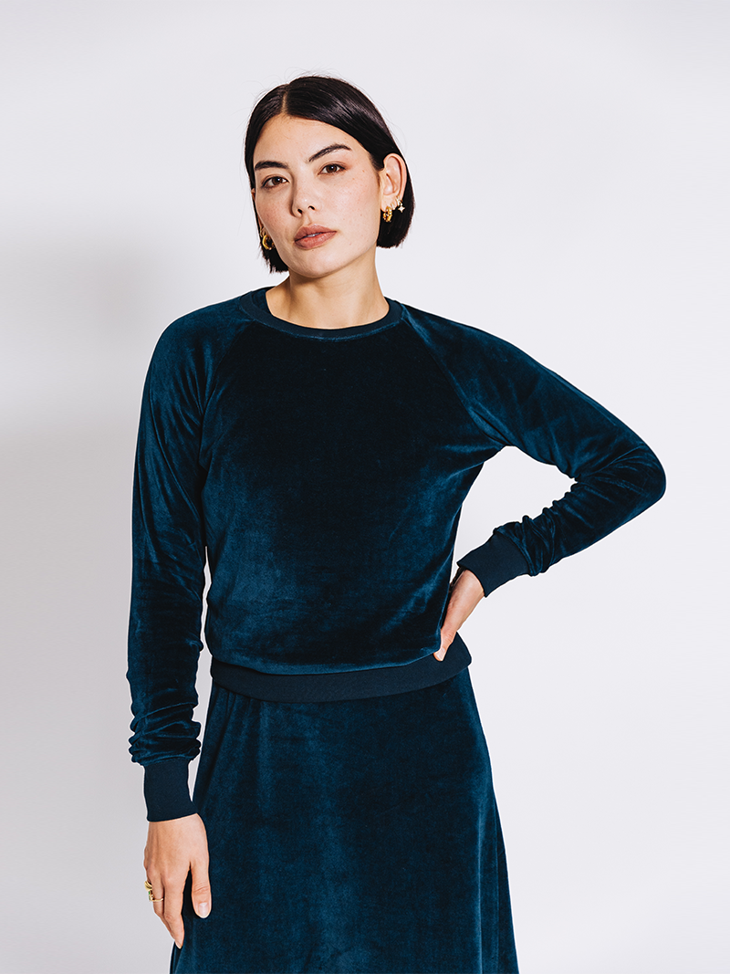 close up of woman modelling Organic Velour Dress in green