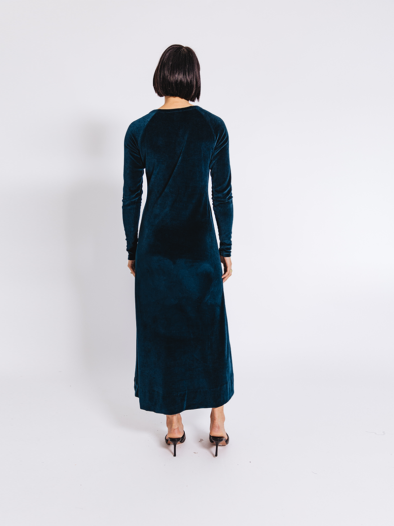 woman modelling Organic Velour Dress in green, back view